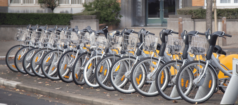 a row of bicycles parked in front of a building