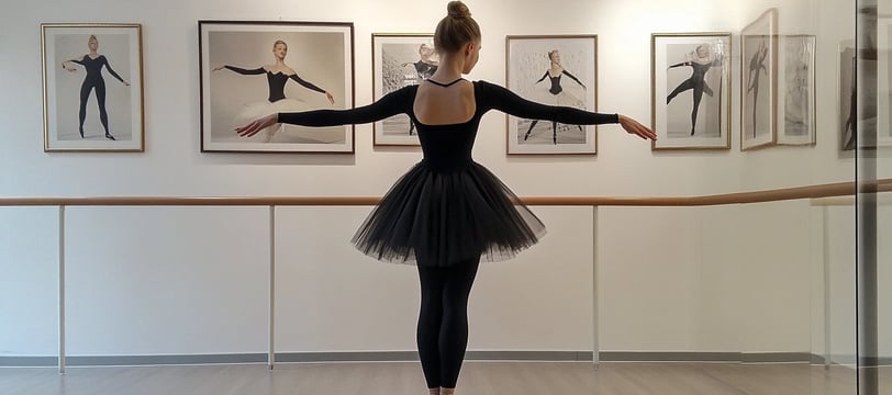 a woman in a black dress and a ballet outfit