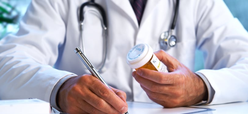 A medical practitioner prescribing medication