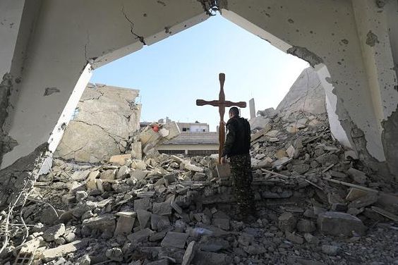 a man standing in a room with a cross on it