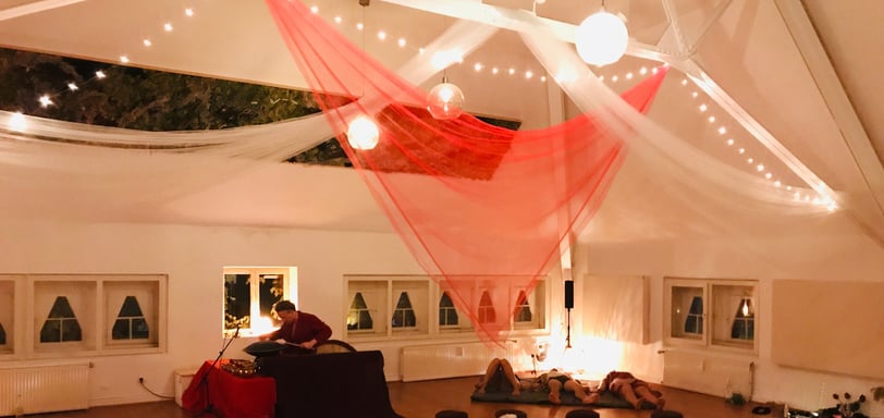 a room with a lot of people sitting on the floor