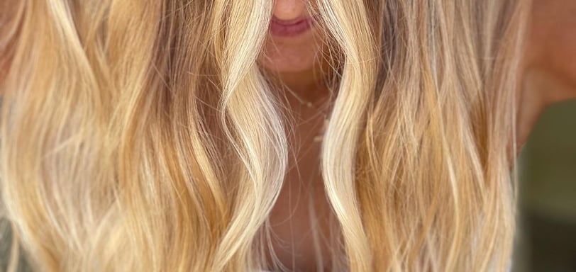 a woman with golden blonde hair, colored by hair by raqual rose