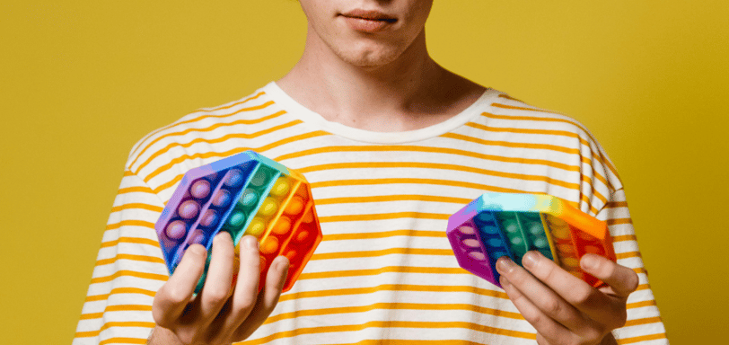 boy holding fidget toys.  ADHD Stimming