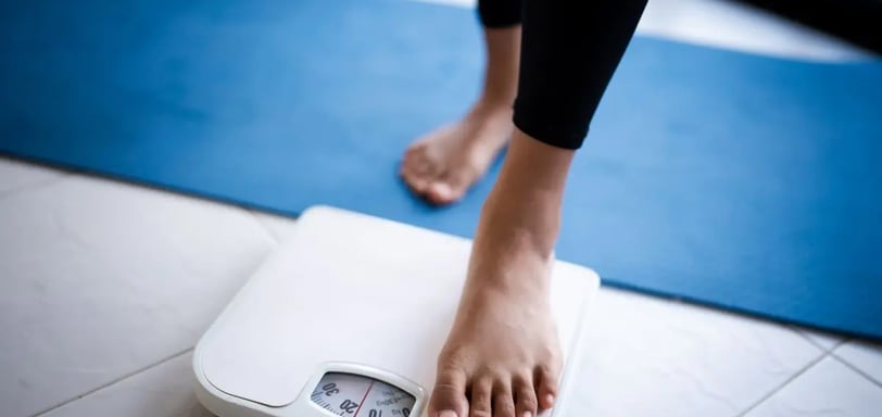 bathroom scale with feet stepping on .