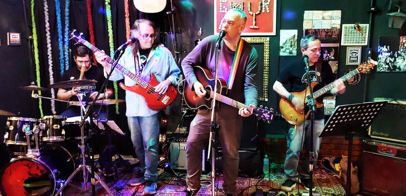 a band playing guitar in a bar
