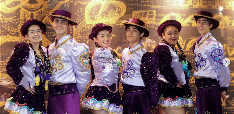 a group of young people in colorful costumes