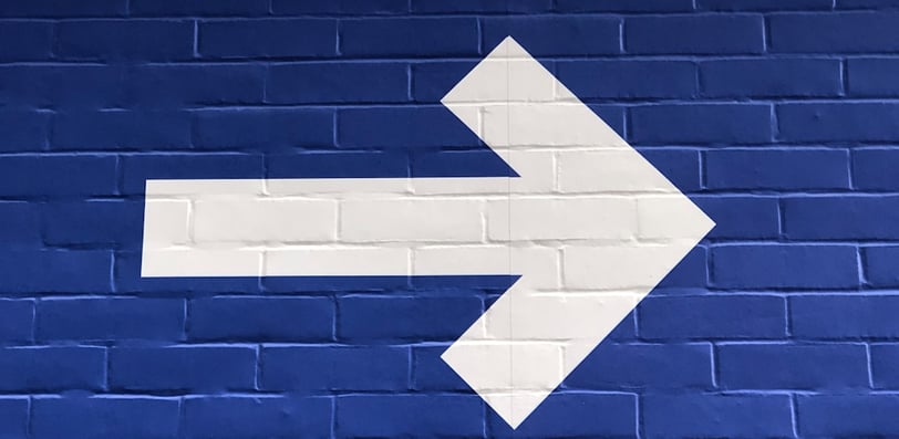 White arrow pointing right, symbolizing direction.