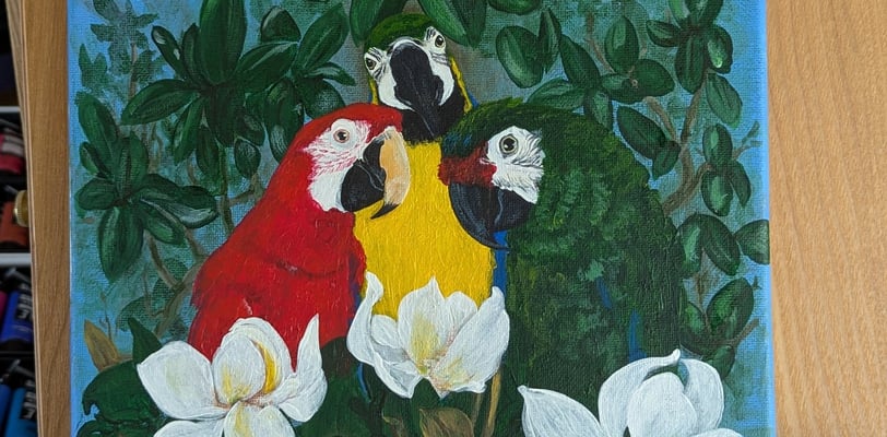 Finished canvas painting of 3 macaws in a magnolia tree.