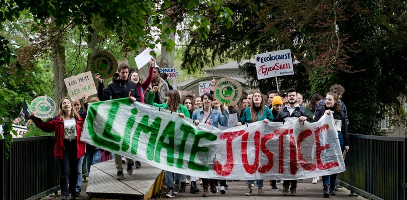 a group of people holding signs and holding signs