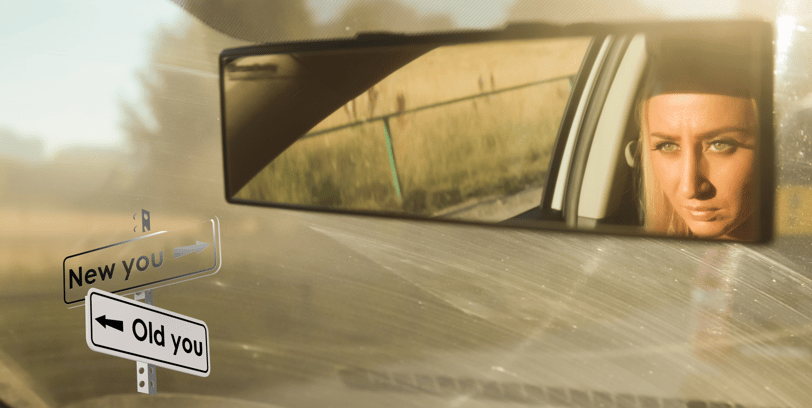 a woman driving a car with a cloudy windshield