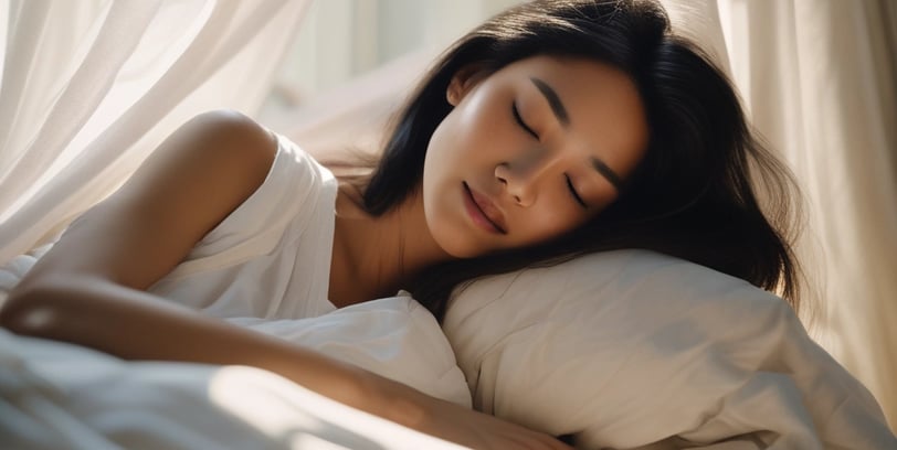 Person sleeping peacefully in bed with cozy bedding, by Regal Touch Home.
