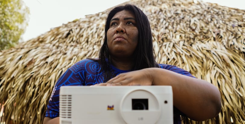 a woman holding a projector and a projector