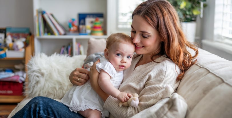 a woman holding a baby in her arms