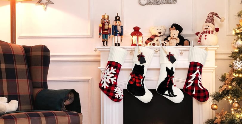 a christmas tree with stockings and stockings hanging on a fireplace