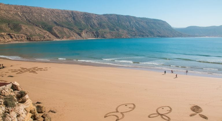 Morocco a couple of people walking on a beach