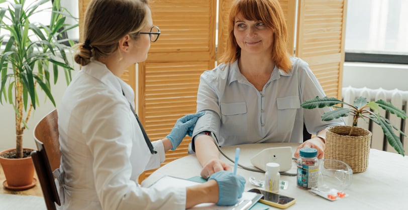 Doctor discussing importance of annual wellness exams for female patient over 40