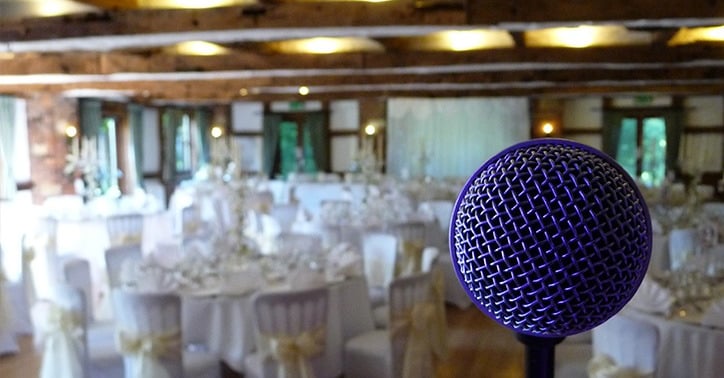 a microphone in a wedding breakfast room with tables and chairs