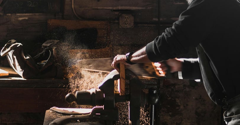 a woodworker cutting wood