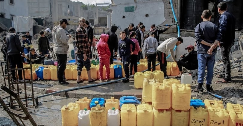 Citizens in Gaza stand in long lines to get water.