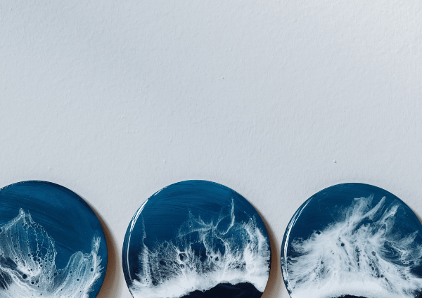three plates with waves on it with the paint