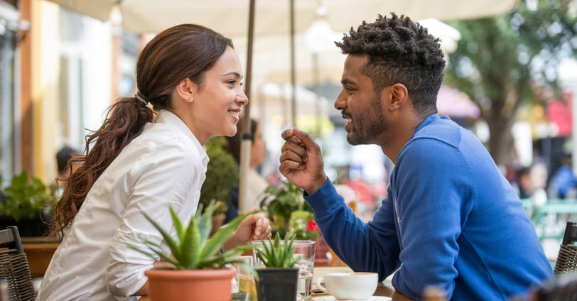a man and woman sitting at a table