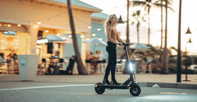 a woman riding a scooter in a city
