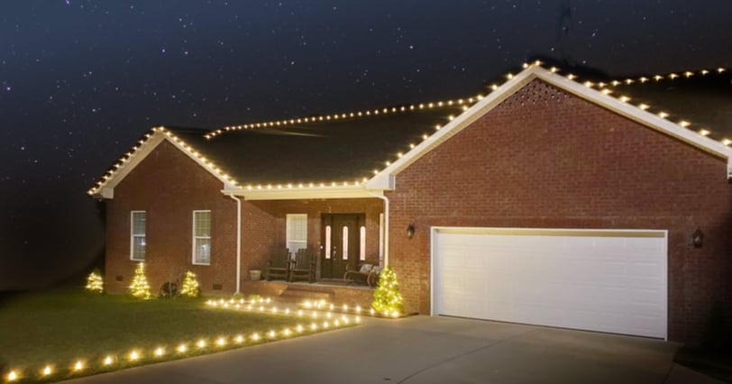 Angled view of home with Christmas lights installed