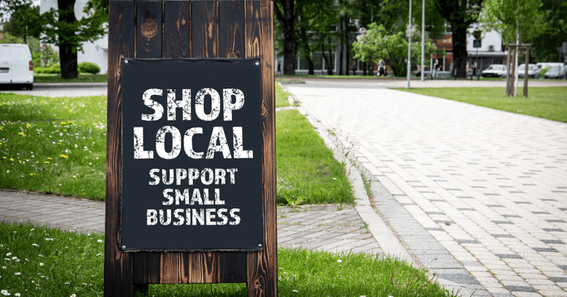 a sign board with a sign saying shop local