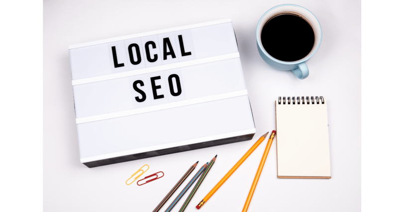 Local SEO concept with sign, coffee, notebook, and pencils, Boost small business online visibility
