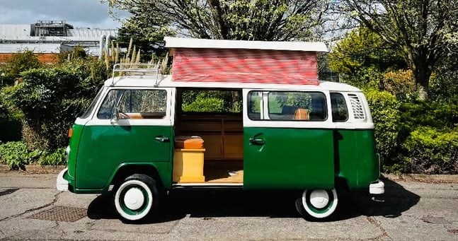 Classic green Camper van with roof tent