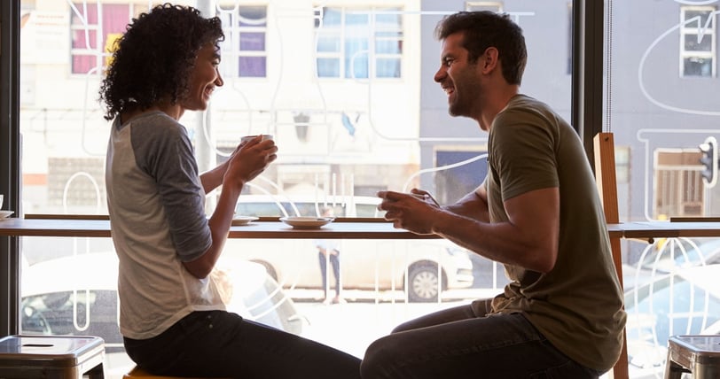 a man and woman sitting at a table