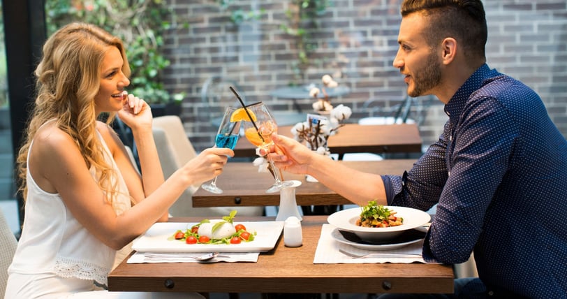 a man and woman are having a drink together