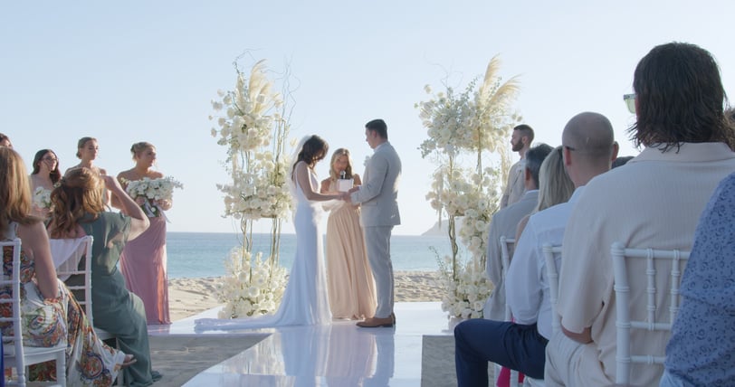 A captured moment showing a married couple standing at the altar on a beach in Los Cabos, at Garza Blanca. Captured by our vi