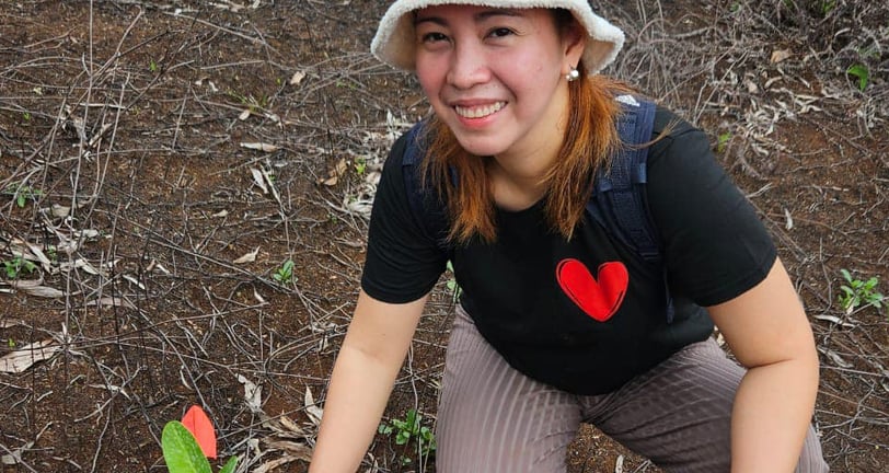 woman planting tree on guam