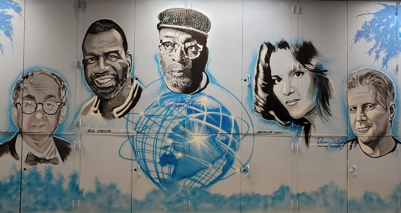 A mural inside of a classroom celebrating people associated with the school.