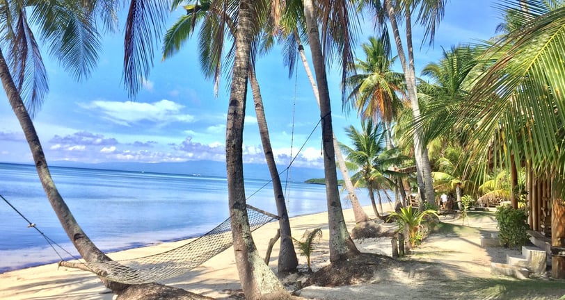 Siquijor beach side at San Juan with palm trees and a hammock