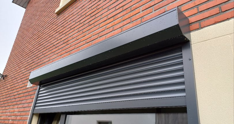 a window with a roller shuttered door and a window with a window