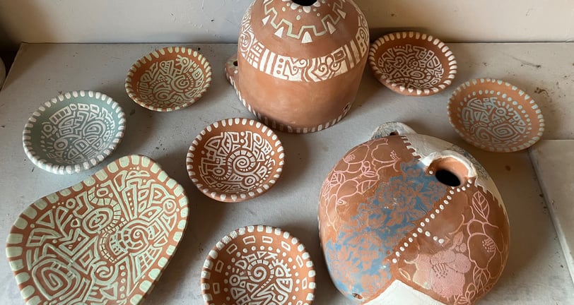 Pottery dishes and bird houses ready to glaze