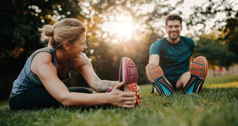 a man and woman doing a stretching exercise