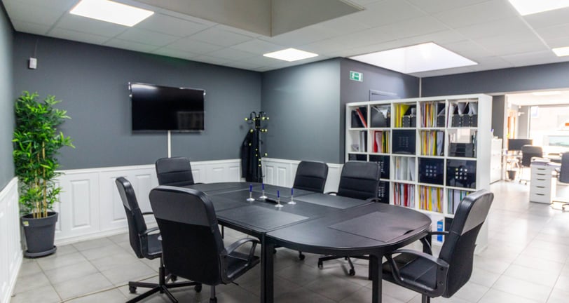 a conference room with a table and chairs