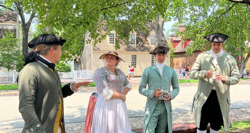 Colonial costumed villages chatting in the street in Williamsburg
