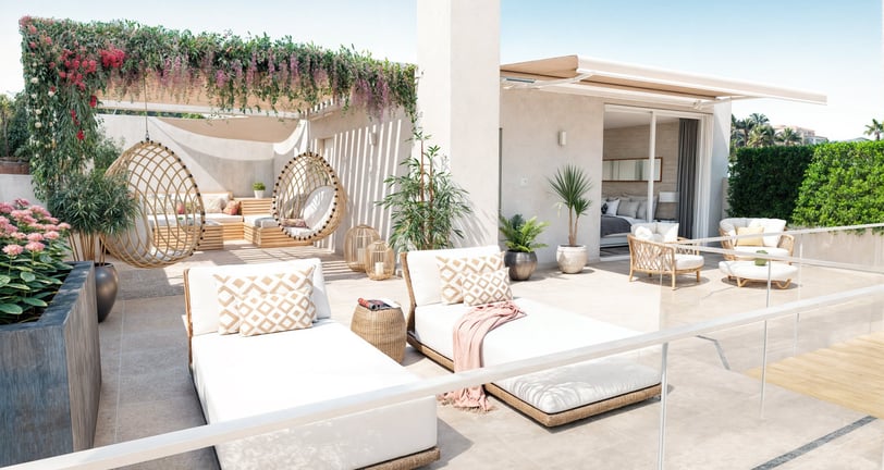 a patio with a white couch and a white couch