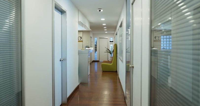 a hallway with a chair and a chair in the middle of the hallway
