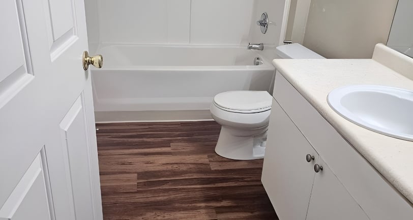 clean bathroom wooden floor beige cabinets