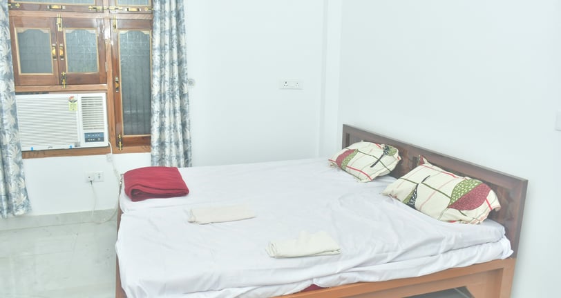 a bed with a white bed and a window