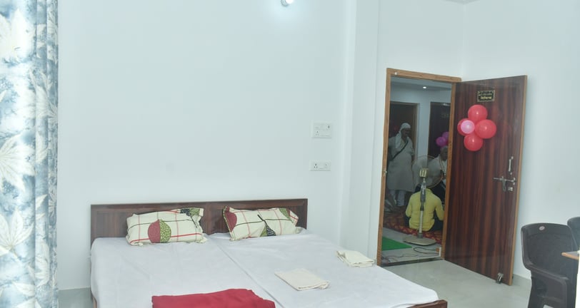 a bed with a bed and a table with balloons