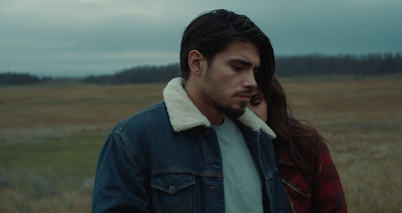 a man and woman standing in a field