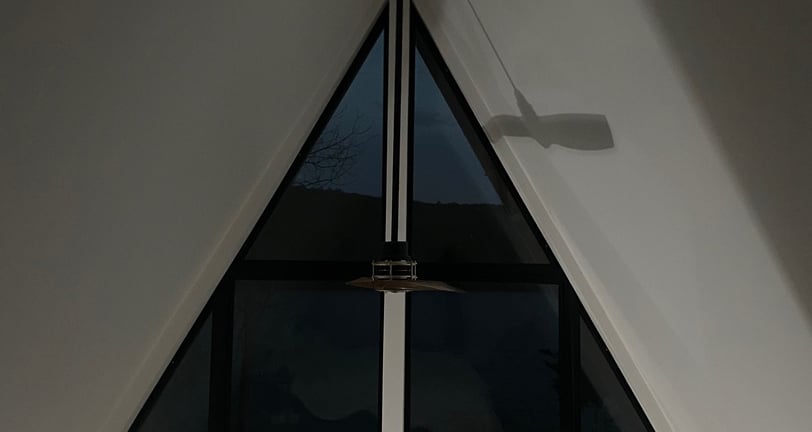 custom A-frame window wall with trim free drywall