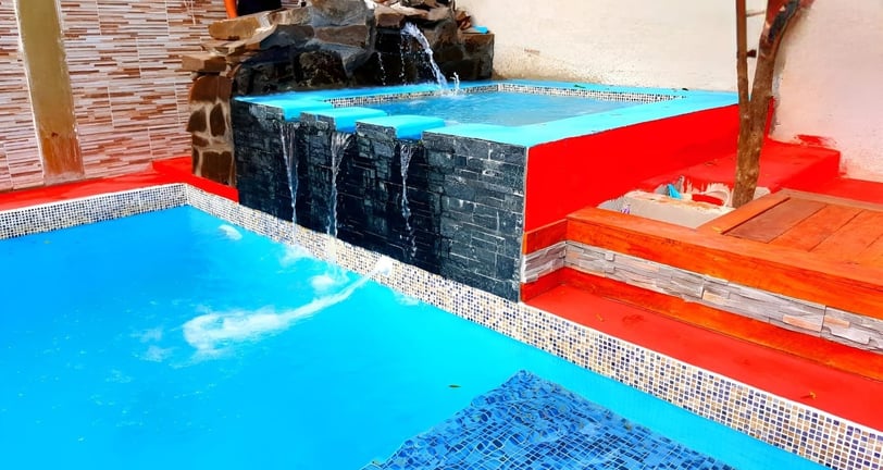 a pool with a waterfall and a waterfall