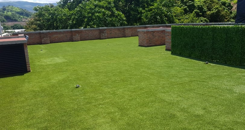 Pasto sintético verde instalado en jardín residencial en Guadalajara